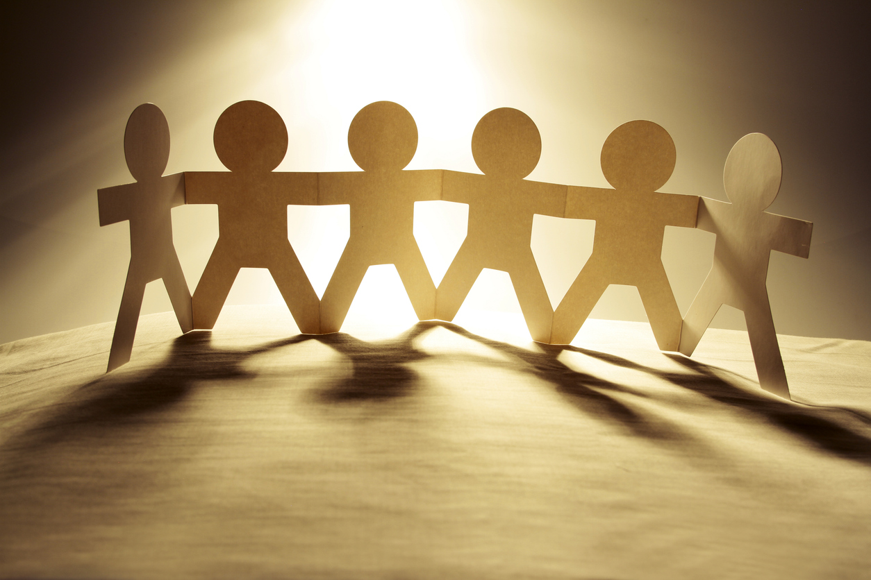 paper chain people in a row holding hands